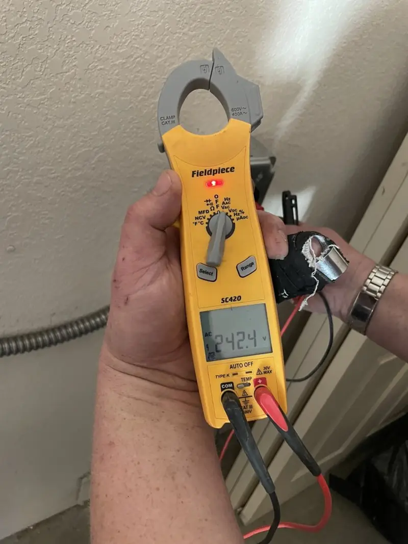 Voltage testing with clamp meter during Outlet Installation in Bayonet Point